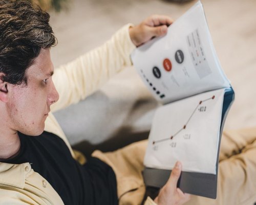A person reading financial information clarity reports